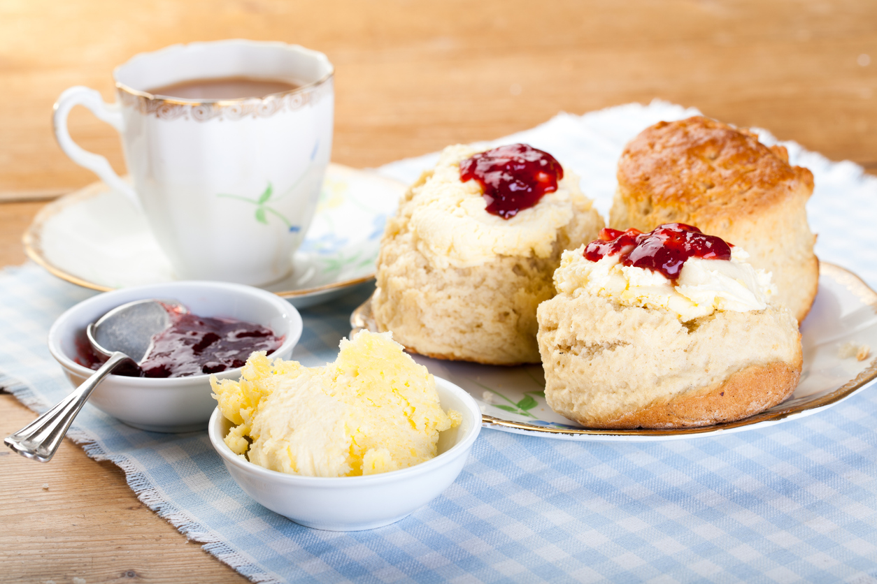 Traditional scones, cream and jam served with a cup of tea