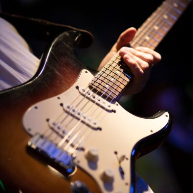 Close up of an electric guitar being played