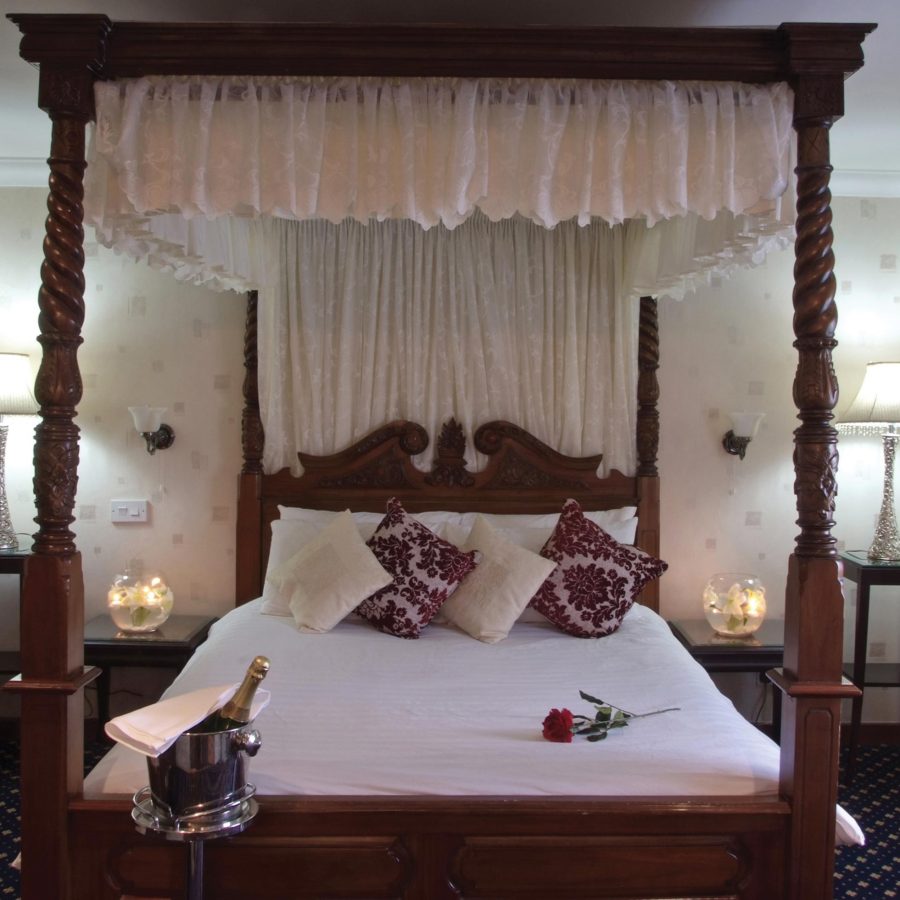 A four poster bed in a Romantic Jacuzzi Room at The Durrant House Hotel