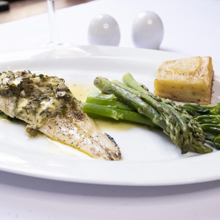 Sea Bass with a lemon herb and caper butter dauphinoise potato and fresh vegetables in the Olive Tree Restaurant