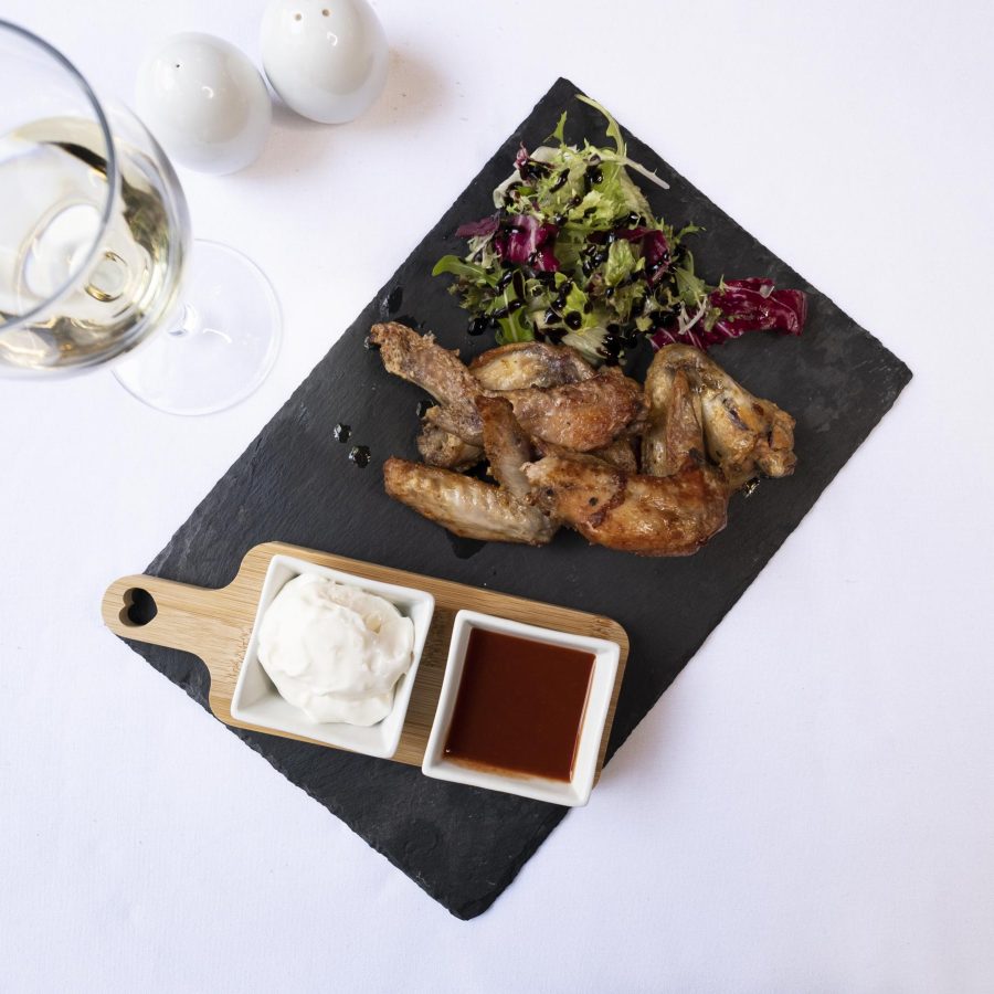 Cajun Chicken Wings starter with Garlic Mayonnaise Hot Sauce and Salad Garnish in the Olive Tree Restaurant