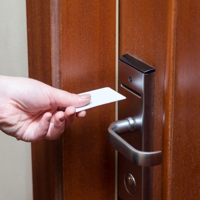 Hotel room card being used to open door